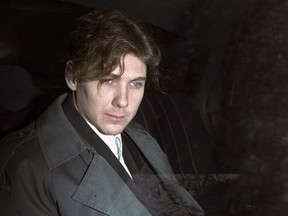 Paul Bernardo sits in the back of a police cruiser as he leaves a hearing in St. Catharines, Ont., April 5, 1994.