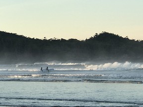 Wading into the crashing surf at Cox Bay.