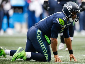 Quarterback Russell Wilson #3 of the Seattle Seahawks on the ground in the second half against the Los Angeles Rams at CenturyLink Field on October 7, 2018 in Seattle, Washington.