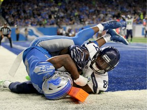 Ed Dickson #84 of the Seattle Seahawks scores a touchdown against Quandre Diggs #28 of the Detroit Lions during the second quarter at Ford Field on October 28, 2018 in Detroit, Michigan.