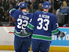 Daniel Sedin #22 and Henrik Sedin #33 of the Vancouver Canucks skate on the ice against the Dallas Stars during Game 7 of the 2007 Western Conference Quarterfinals.