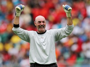 DURBAN, SOUTH AFRICA - NOVEMBER 16: In this handout image provided by the ITM Group,   Bruce Grobbelaar celebrates during the Legends match between Liverpool FC Legends and Kaizer Chiefs Legends at Moses Mabhida Stadium on November 16, 2013 in Durban, South Africa.