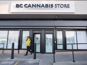 A security guard walks outside British Columbia's first legal B.C. cannabis store in Kamloops, B.C. Tuesday, Oct. 16, 2018. Canada will legalize cannabis nation wide on Wednesday, Oct. 17 2018 allowing stores across the country to open and legally sell cannabis and cannabis products.