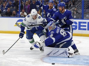 Lightning goaltender Andrei Vasilevskiy makes a save against the Canucks' Bo Horvat.