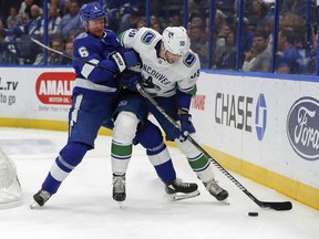 Anton Stralman tries to impede the progress of Tim Schaller on Oct. 11 in Tampa.