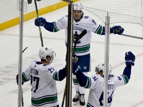 Ben Hutton celebrates with teammates after scoring against the Penguins during the first period of an NHL hockey game, Tuesday, Oct. 16, 2018, in Pittsburgh.