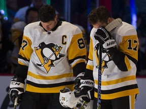 Pittsburgh Penguins forwards Sidney Crosby and Bryan Rust bow their heads during a moment of silence to honour the shooting victims in Pittsburgh prior to playing the Vancouver Canucks in a regular season NHL hockey game at Rogers Arena on Oct. 27.