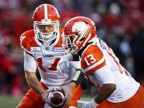 BC Lions quarterback Travis Lulay, left, hands the ball off to Tyrell Sutton, during CFL football action against the Calgary Stampeders, in Calgary on October 13, 2018. It's win and you're in for the B.C. Lions. The team can secure a spot in the CFL playoffs on Friday with a win over the visiting Edmonton Eskimos. The Lions (8-7) struggled to start the season, but have now won five of their last six, while the Eskimos (8-8) ended a three-game skid with a win over the Redblacks last week.