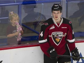 A young girl giggles as she watches Vancouver Giants #44 Bowen Byram on the ice during the pregame skate prior to playing the Seattle Thunderbirds in a regular season WHL hockey game at the LEC. Langley, September 28 2018.