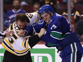 Boston Bruins' Noel Acciari (55) fights Vancouver Canucks' Bo Horvat (53) during second period NHL hockey action in Vancouver on Saturday, Oct. 20, 2018.