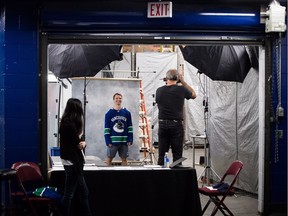 Forward Antoine Roussel of the Vancouver Canucks was all smiles when he had his headshot taken by the team photographer last month. The smile returned Friday when he skated on the team's first line in practice.