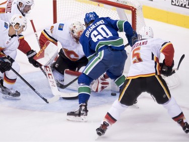 Vancouver Canucks center Markus Granlund (60) fails to get a shot past Calgary Flames goaltender Mike Smith (41) during second period NHL action at Rogers Arena in Vancouver, Wednesday, Oct, 3, 2018.