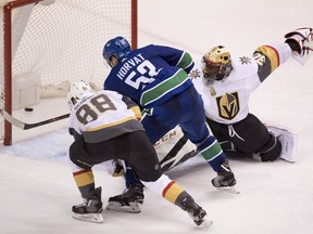 Vegas Golden Knights defenceman Nate Schmidt (88) looks on as Vancouver Canucks center Bo Horvat (53) scores past Vegas Golden Knights goaltender Malcolm Subban (30) during third period NHL action at Rogers Arena in Vancouver, Tuesday, April, 3, 2018.