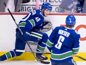 Elias Pettersson celebrates one of his two goals Monday with Brock Boeser.