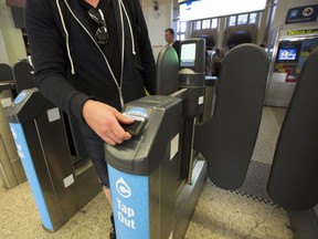 A public transit commuter taps out with his Compass card at Vancouver’s Waterfront Station.
