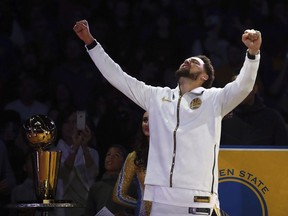 Golden State Warriors' Klay Thompson celebrates after receiving his championship ring during an awards ceremony to recognize the Warriors' NBA championship prior to an NBA basketball game against the Oklahoma City Thunder, Tuesday, Oct. 16, 2018, in Oakland, Calif.