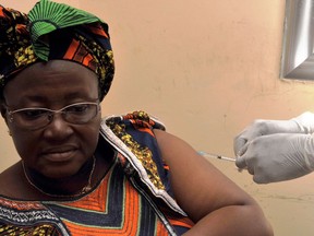 A woman gets vaccinated on at a health centre in Guinea during the first clinical trials of the VSV-EBOV vaccine against the Ebola virus.