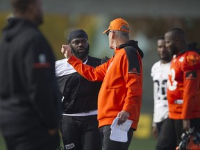Solomon Elimimian, who is close to returning to the B.C. Lions lineup, listens to coaching advice during the CFL team's practice in Surrey on Wednesday.