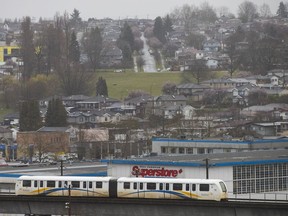 A SkyTrain car rides on the Millennium Line close to Renfrew Station.