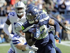 In this Sunday, Sept. 23, 2018, file photo, Seattle Seahawks running back Chris Carson rushes against the Dallas Cowboys during the first half of an NFL football game in Seattle. Carson rushed for 102 yards in the game. In consecutive weeks, the Seahawks produced 100-yard rushers. The novelty was it being two different backs, neither of which was rookie first-round pick Rashaad Penny.
