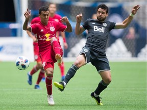 New York Red Bulls' Alejandro Gamarra, left, and Vancouver Whitecaps' Felipe Martins vie for the ball during the first half of an MLS at B.C. Place in August.