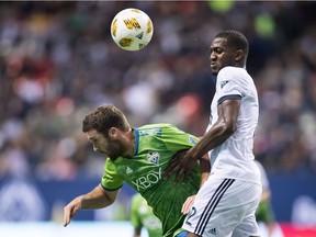 File photo: Seattle Sounders' Will Bruin, left, and Vancouver Whitecaps' Doneil Henry vie for the ball during the second half of an MLS soccer game in Vancouver, on Saturday September 15, 2018.