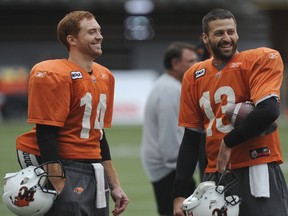 Travis Lulay, left, and Mike Reilly were teammates with the B.C. Lions in 2012, and even though they now play for different teams — Reilly's in Edmonton — they remain great friends. The quarterbacks face each other Friday at B.C. Place Stadium in a CFL game with plenty on the line.