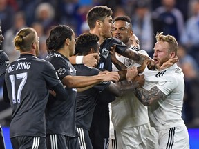 FILE PHOTO Sporting KC forward Johnny Russell (7) reacts after getting shoved to the ground by Vancouver Whitecaps forward Yordi Reyna (29) during the first half at Children's Mercy Park April 20, 2018.