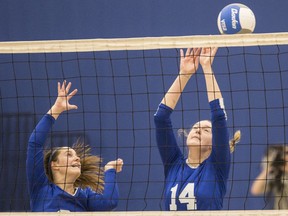 Belmont Bulldogs Taylee Pomponio,left, and Gracie May block the ball against the Oak Bay Bays in Island AAAA girls volleyball championship at Belmont Secondary School in Victoria, B.C. November  18, 2017.