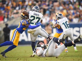 Running back Mike Davis of the Seattle Seahawks is tackled by defensive back Nickell Robey-Coleman of the Los Angeles Rams in the fourth quarter.