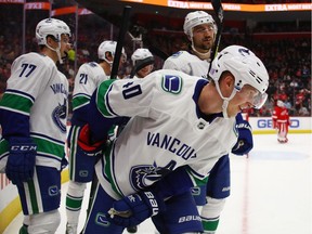 Elias Pettersson celebrates his first-period goal with teammates.