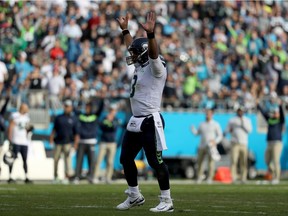 Russell Wilson of the Seattle Seahawks reacts against the Carolina Panthers in the third quarter during their game at Bank of America Stadium on November 25, 2018 in Charlotte, North Carolina.