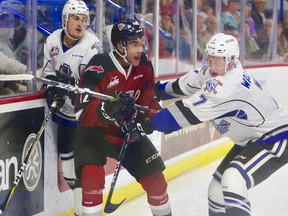 Justin Sourdif of the Vancouver Giants battles with a pair of Victoria Royals in Saturday night's 4-1 Vancouver win.