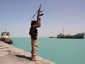 In this file photo taken on February 08, 2017, a member of the pro-government forces raises his weapon in the port of the western Yemeni coastal town of Mokha as the Saudi-backed troops advance in a bid to try to drive the Shiite Huthi rebels away from the Red Sea coast.