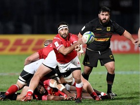 Canada's scrum half Phil Mack passes the ball next to Germany's prop Matthias Schosser (R) during the 2019 Japan Rugby Union World Cup qualifying match between Canada and Germany at the Delort Stadium on Nov. 17, 2018 in Marseille, France.