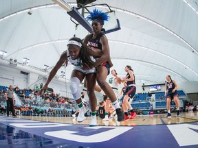 Notre Dame's Jackie Young, front left, and Gonzaga's Zykera Rice battle for the ball during Thursday's action in an NCAA women's college basketball game in Vancouver.