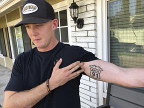Brendan Kelly speaks with reporters outside his home, as he shows his Route 91 tattoo, Thursday, Nov. 8, 2018, in Thousand Oaks, Calif.