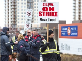 Canada Post workers walk the picket line as a rotating strike continues in Halifax on Tuesday, Nov. 13, 2018.