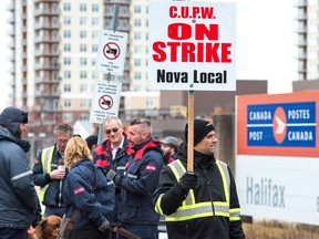Canada Post workers walk the picket line during a rotating strike in Halifax earlier this month.