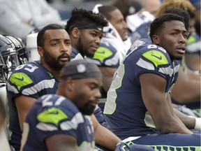 Seattle Seahawks players, including receivers Doug Baldwin (upper left) and David Moore (right) look dejected sitting on the bench late in the second half of their NFL game against the Los Angeles Chargers, on Sunday, Nov. 4, 2018, in Seattle. The Chargers won 25-17.