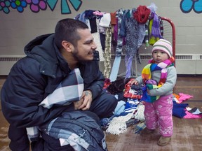 Twenty-one-month-old Elizabeth Sammy and dad Kyle check out some of the clothes that were collected through the Coats for Kids campaign at Saskatoon in 2016. This year in Metro Vancouver, members of the homebuilders' association have once again opened their doors as drop-off locations for people to donate new and lightly used coats and new toys in support of the Lower Mainland and Surrey Christmas bureaus.