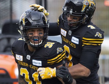 Hamilton Tiger-Cats wide receiver Marquay McDaniel (3) congratulates teammate Sean Thomas Erlington (31) after his touchdown during first half CFL Football division semifinal game action against the B.C. Lions in Hamilton, Ont. on Sunday, November 11, 2018.