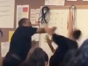 Maywood Academy High School teacher Marston Riley fights with a student.