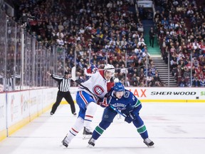 Montreal Canadiens' Kenny Agostino, left, skates around Vancouver Canucks' Troy Stecher during third period NHL hockey action in Vancouver, on Saturday, Nov. 17, 2018.