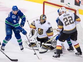Vancouver Canucks' Jake Virtanen (18) redirects a shot in front of Vegas Golden Knights goalie Marc-Andre Fleury, centre, as Nick Holden (22) and Vancouver's Michael Del Zotto, back right, watch during the second period of an NHL hockey game in Vancouver, on Thursday November 29, 2018.