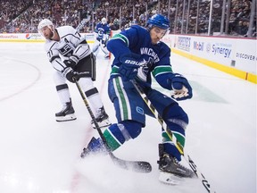Vancouver Canucks' Michael Del Zotto, right, falls in front of Los Angeles Kings' Jeff Carter during the third period of an NHL hockey game in Vancouver, on Tuesday November 27, 2018.