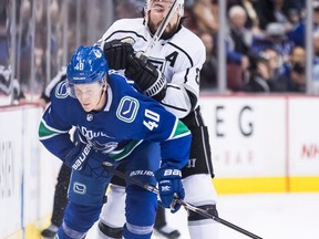 Los Angeles Kings' Drew Doughty, back, checks Vancouver Canucks' Elias Pettersson, of Sweden, during the third period of an NHL hockey game in Vancouver, on Tuesday November 27, 2018.