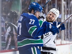 Ben Hutton and Kyle Clifford go bump in the night during first-period play Tuesday.