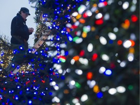 George Grigore checks the Christmas lights on the display that covers his home in the 6300-block of 165A Street in Surrey. The Grigores use LEDs to moderate their December power use.