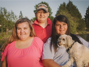Erin McKinney with her adopted son Nathaniel, holding dog, and Nathaniel's uncle Brad, centre. Nathaniel and McKinney are second cousins, sharing a grandfather.